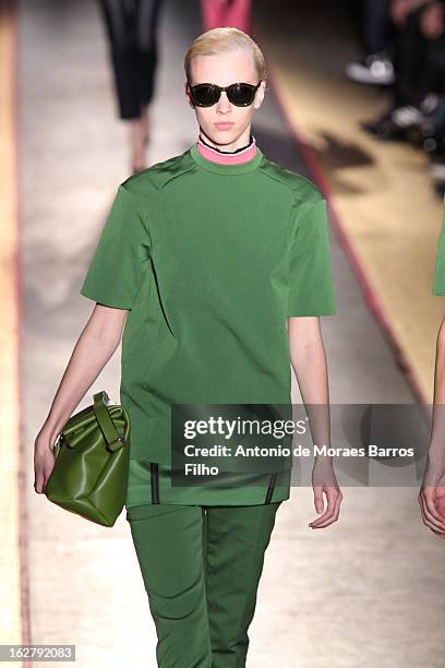 Model walks the runway during the Cedric Charlier Fall/Winter 2013 Ready-to-Wear show as part of Paris Fashion Week on February 26, 2013 in Paris,...