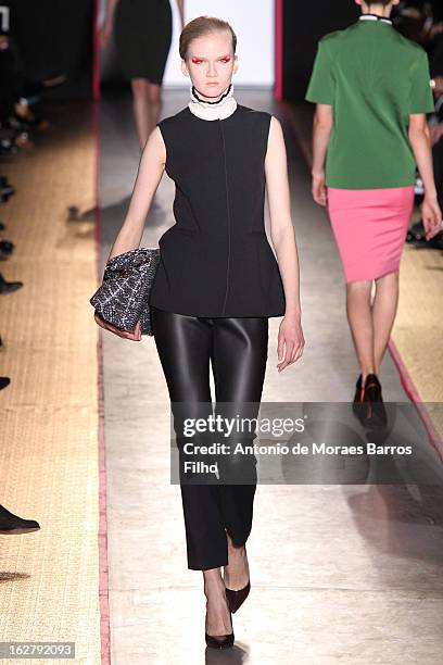 Model walks the runway during the Cedric Charlier Fall/Winter 2013 Ready-to-Wear show as part of Paris Fashion Week on February 26, 2013 in Paris,...