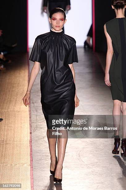 Model walks the runway during the Cedric Charlier Fall/Winter 2013 Ready-to-Wear show as part of Paris Fashion Week on February 26, 2013 in Paris,...