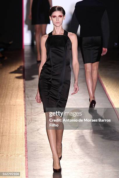 Model walks the runway during the Cedric Charlier Fall/Winter 2013 Ready-to-Wear show as part of Paris Fashion Week on February 26, 2013 in Paris,...