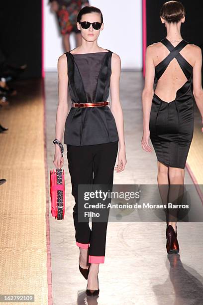 Model walks the runway during the Cedric Charlier Fall/Winter 2013 Ready-to-Wear show as part of Paris Fashion Week on February 26, 2013 in Paris,...