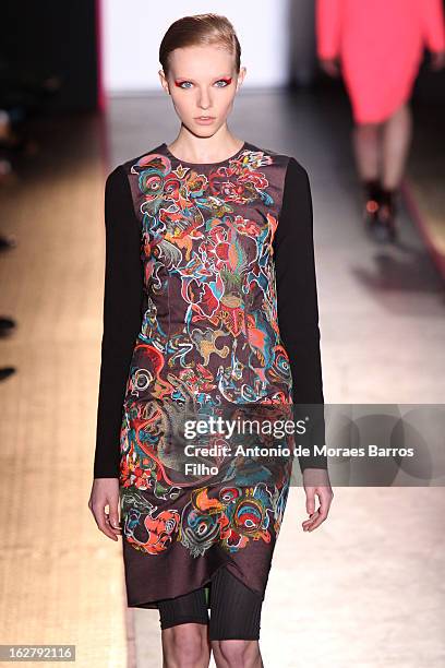 Model walks the runway during the Cedric Charlier Fall/Winter 2013 Ready-to-Wear show as part of Paris Fashion Week on February 26, 2013 in Paris,...