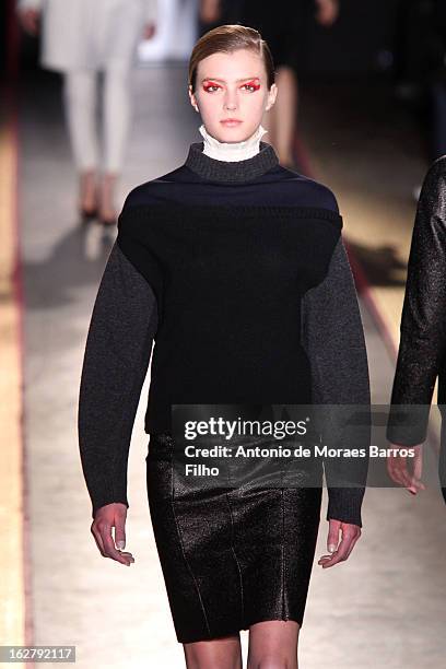 Model walks the runway during the Cedric Charlier Fall/Winter 2013 Ready-to-Wear show as part of Paris Fashion Week on February 26, 2013 in Paris,...