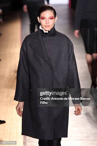 Model walks the runway during the Cedric Charlier Fall/Winter 2013 Ready-to-Wear show as part of Paris Fashion Week on February 26, 2013 in Paris,...