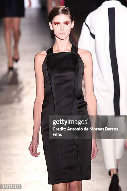 Model walks the runway during the Cedric Charlier Fall/Winter 2013 Ready-to-Wear show as part of Paris Fashion Week on February 26, 2013 in Paris,...