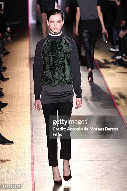 Model walks the runway during the Cedric Charlier Fall/Winter 2013 Ready-to-Wear show as part of Paris Fashion Week on February 26, 2013 in Paris,...