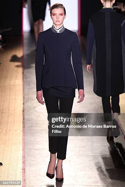 Model walks the runway during the Cedric Charlier Fall/Winter 2013 Ready-to-Wear show as part of Paris Fashion Week on February 26, 2013 in Paris,...