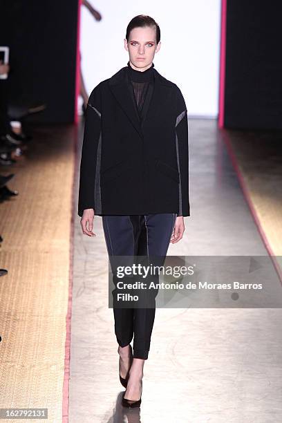 Model walks the runway during the Cedric Charlier Fall/Winter 2013 Ready-to-Wear show as part of Paris Fashion Week on February 26, 2013 in Paris,...