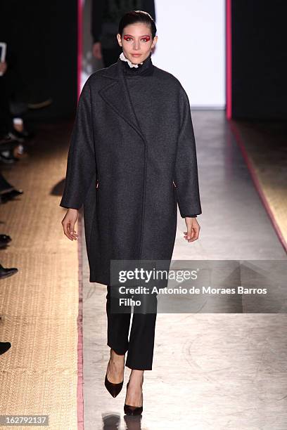 Model walks the runway during the Cedric Charlier Fall/Winter 2013 Ready-to-Wear show as part of Paris Fashion Week on February 26, 2013 in Paris,...