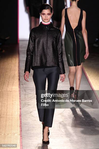 Model walks the runway during the Cedric Charlier Fall/Winter 2013 Ready-to-Wear show as part of Paris Fashion Week on February 26, 2013 in Paris,...