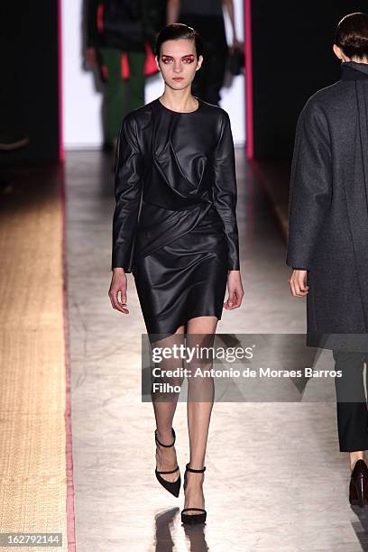 Model walks the runway during the Cedric Charlier Fall/Winter 2013 Ready-to-Wear show as part of Paris Fashion Week on February 26, 2013 in Paris,...