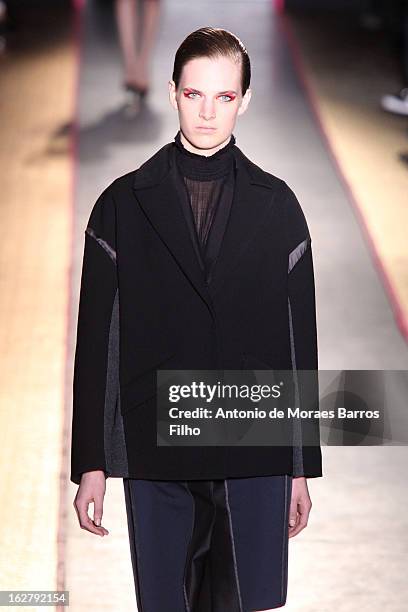 Model walks the runway during the Cedric Charlier Fall/Winter 2013 Ready-to-Wear show as part of Paris Fashion Week on February 26, 2013 in Paris,...