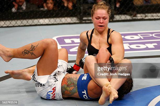 Ronda Rousey attempts to secure an arm bar submission against Liz Carmouche in their women's bantamweight title fight during UFC 157 at Honda Center...