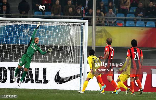 Kashiwa Reysol's goalkeeper Sugeno Takanori clears a shot at goal against Guizhou Renhe in the AFC Champions group H match in Guiyang Olympic Centre...