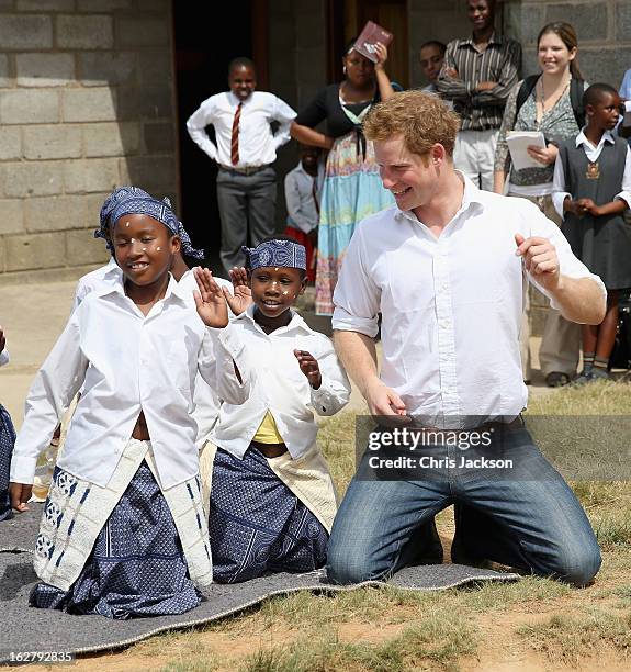 Prince Harry dances with deaf children during at visit to the Kananelo Centre for the deaf, a project supported by his charity Sentebale on February...