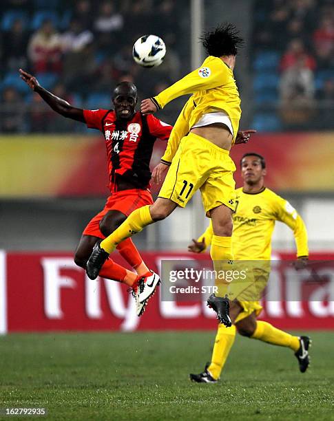 Kashiwa Reysol's Cleo tussles for the ball against Guizhou Renhe's Jonas Salley in the AFC Champions group H match in Guiyang Olympic Centre Stadium,...