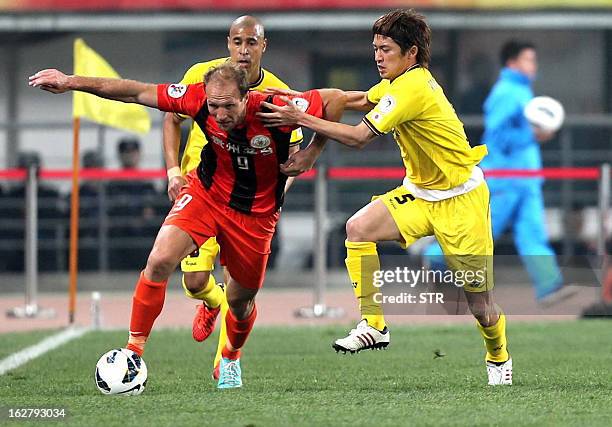 Kashiwa Reysol's Tatsuya Masushima tussles for the ball against Guizhou Renhe's Zlatan Muslimovic in the AFC Champions group H match in Guiyang...