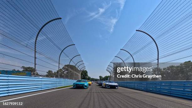 Denny Hamlin, driver of the Mavis Tires & Brakes Toyota, and William Byron, driver of the Valvoline Chevrolet, lead the field on a pace lap prior to...