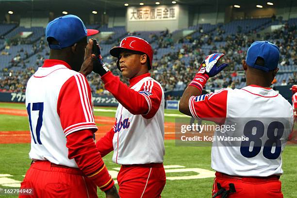 Outfielder Frederich Cepeda of Cuba celebrates an RBI single in the top half of the fifth inning during the friendly game between Hanshin Tigers and...