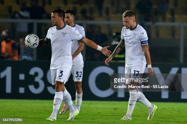 Ciro Immobile and Luca Pellegrini of Lazio react during the Serie A TIM match between US Lecce v SS Lazio at Stadio Via del Mare on August 20, 2023...