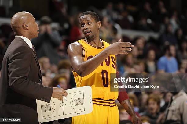 Byron Scott and C.J. Miles of the Cleveland Cavaliers discuss a play during the game against the Atlanta Hawks at The Quicken Loans Arena on December...