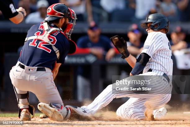 Isiah Kiner-Falefa of the New York Yankees slides into home as Connor Wong of the Boston Red Sox attempts the tag during the eighth inning at Yankee...