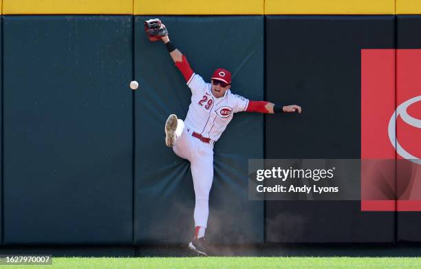 Friedl of the Cincinnati Reds fails to catch the ball against the outfield wall in the game against the Blue Jays at Great American Ball Park on...