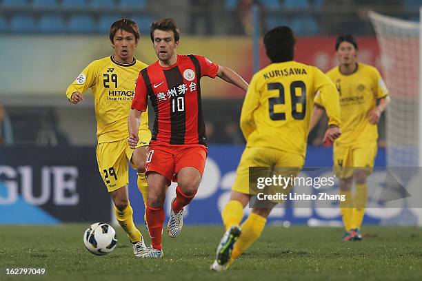 Zlatan Muslimovic of Guizhou Renhe challenges Hiroyuki Taniguchi and Ryoichi Kurisawa of Kashiwa Reysol during the AFC Champions League match between...