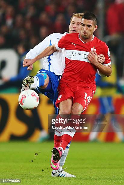 Federico Macheda of Stuttgart is challenged by Lukas Sinkiewicz of Bochum during the DFB Cup Quarter Final match between VfB Stuttgart and VfL Bochum...