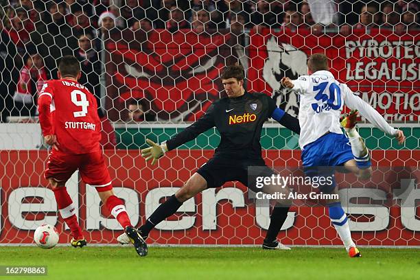 Vedad Ibisevic of Stuttgart scores his team's second goal against goalkeeper Andre Luthe and Michael Lumb of Bochum during the DFB Cup Quarter Final...