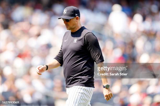 Manager Aaron Boone of the New York Yankees walks to the dugout during the sixth inning against the Boston Red Sox at Yankee Stadium on August 20,...