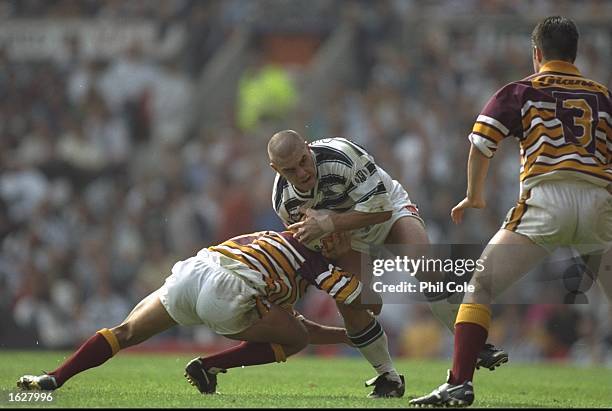 Ali Dauys of Huddersfield tackles Rob Danby of Hull during the Stones Bitter Division final at Old Trafford in Manchester, England. Huddersfield won...
