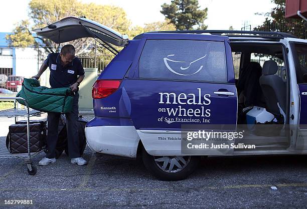 Meals On Wheels of San Francisco driver loads meals into a van before making deliveries on February 27, 2013 in San Francisco, California. Programs...