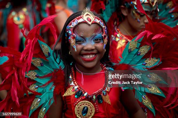 Young performer parades in costume on families and children's day at Notting Hill Carnival on August 27, 2023 in London, England. The annual...
