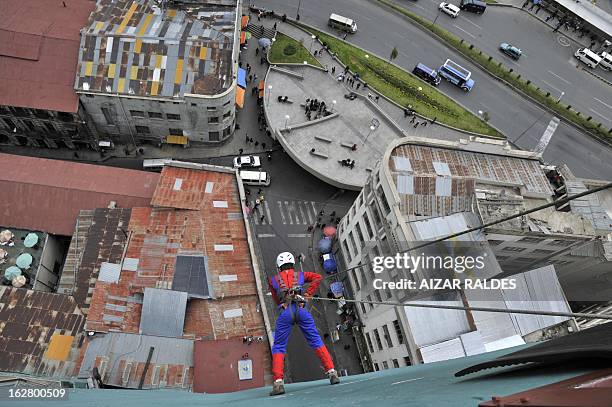 Israeli tourist Liron Sitrek goes down the wall of a hotel in La Paz on February 27, 2013. Sitrek went down some 50 meters from the 17th floor of a...