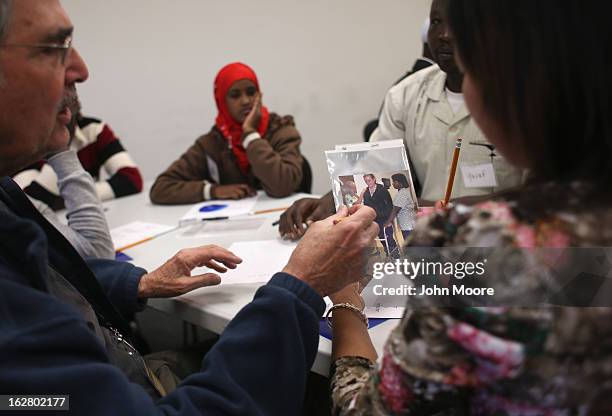Refugees discuss employment descriptions at a job readiness class held at the International Rescue Committee , center on February 27, 2013 in Tucson,...