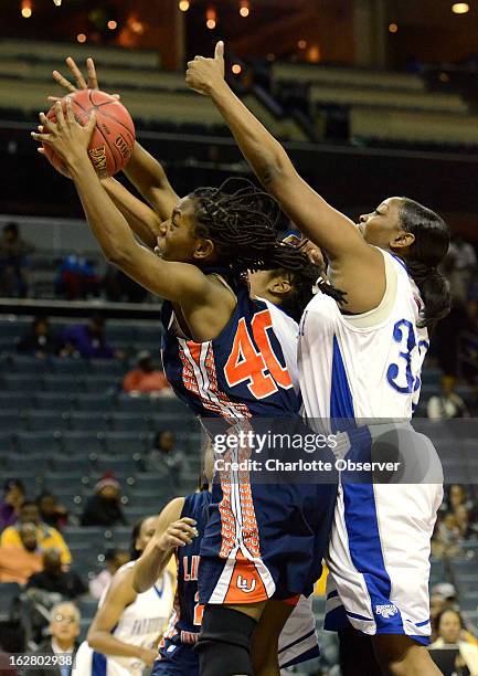 Lincoln University's Tahlar McIntosh pulls down a rebound against Fayetteville State's Tierra Coleman, right, in CIAA Tournament action on Wednesday,...