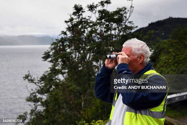 Self-proclaimed Nessie hunter Michael Holian watches over Loch Ness in the hope of spotting the elusive monster Nessie in Scotland on August 27,...