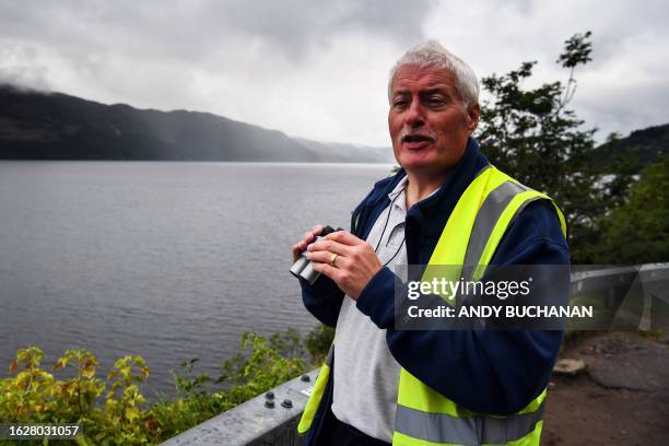 Self-proclaimed Nessie hunter Michael Holian watches over Loch Ness in the hope of spotting the elusive monster Nessie in Scotland on August 27,...