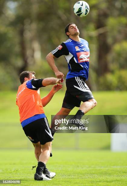 Jarrod Kyle heads the ball above Lucas Neill during a Sydney FC A-League training session at Macquarie Uni on February 28, 2013 in Sydney, Australia.