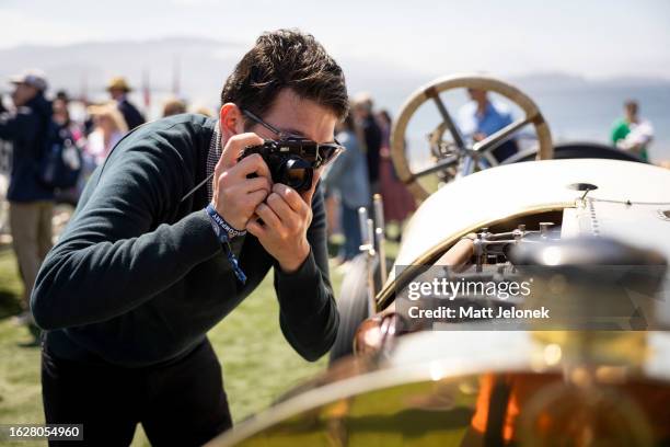 An attendee is seen photographing at Pebble Beach Concours d'Elegance on August 20, 2023 in Monterey, California. Since 1950, the annual Pebble Beach...