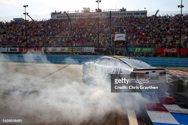 William Byron, driver of the Valvoline Chevrolet, celebrates with a burnout after winning the NASCAR Cup Series Go Bowling at The Glen at Watkins...