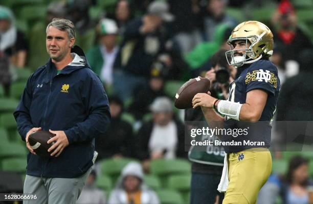 Dublin , Ireland - 26 August 2023; Notre Dame quarterback Sam Hartman and quarterbacks coach / pass game coordinator Gino Guidugli, left, before the...