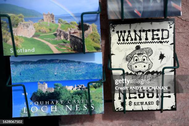 Loch Ness monster-themed postcards are sold at Nessieland in Drumnadrochit in the Scottish Highlands on August 27, 2023. The biggest search for the...