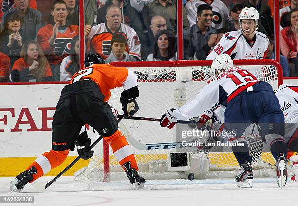 Simon Gagne of the Philadelphia Flyers scores a second period power-play goal, his first after being aquired by the Flyers in a trade yesterday,...