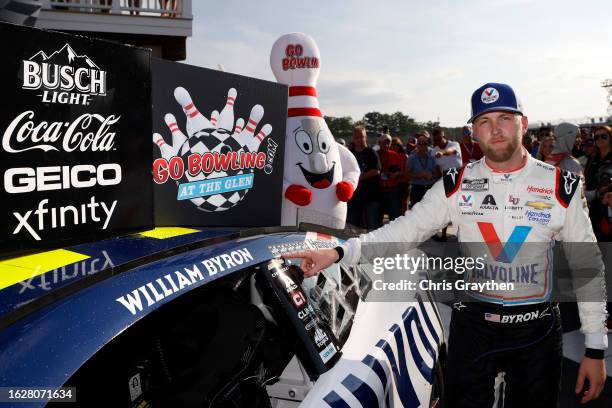 William Byron, driver of the Valvoline Chevrolet, places the winner sticker on his car in victory lane after winning the NASCAR Cup Series Go Bowling...