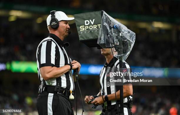 Dublin , Ireland - 26 August 2023; Referee Luke Richmond consults the video replay on a play during the Aer Lingus College Football Classic match...