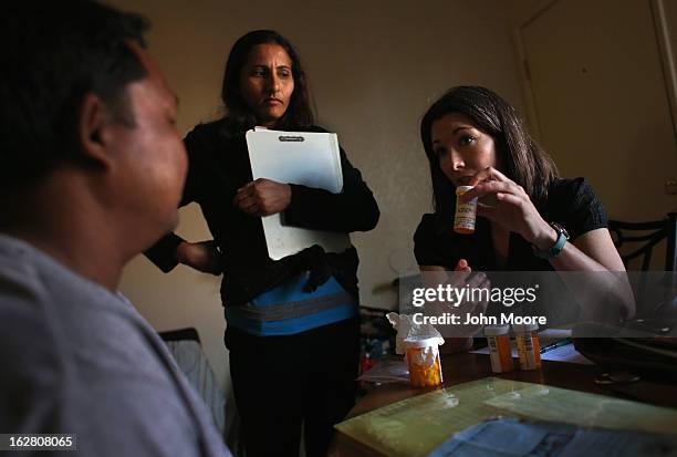 Lauren Schroeder, refugee well-being coordinator for the International Rescue Committee , explains a medical prescription to a Bhutanese refugee...