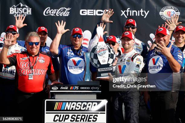 William Byron, driver of the Valvoline Chevrolet, and crew chief Rudy Fugle celebrate in victory lane after winning the NASCAR Cup Series Go Bowling...