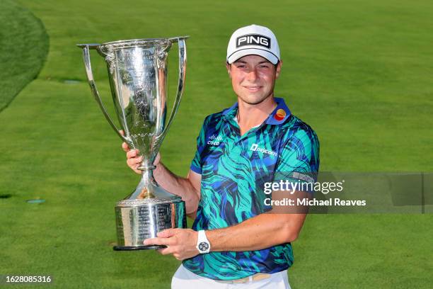 Viktor Hovland of Norway poses with The Western Golf Association Trophy after winning the BMW Championship at Olympia Fields Country Club on August...